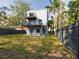 Modern home with balconies overlooking fenced yard and green space, ideal for outdoor enjoyment at 1793 N Fort Harrison Ave, Clearwater, FL 33755