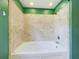 This bathroom features a modern shower-over-tub, tiled walls, and modern shower head at 1793 N Fort Harrison Ave, Clearwater, FL 33755