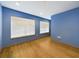 A spacious bedroom with hardwood floors, a large window, and recessed lighting at 1793 N Fort Harrison Ave, Clearwater, FL 33755