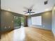 Bedroom with hardwood floors, ceiling fan, sliding glass doors to a balcony, and a window at 1793 N Fort Harrison Ave, Clearwater, FL 33755