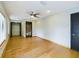Bright bedroom with hardwood floors, ceiling fan, and access to closet and bathroom at 1793 N Fort Harrison Ave, Clearwater, FL 33755