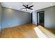 This bedroom features hardwood floors, a ceiling fan, recessed lighting, and an ensuite bathroom at 1793 N Fort Harrison Ave, Clearwater, FL 33755