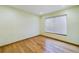 This sunny bedroom has wood floors and window with venetian blinds at 1793 N Fort Harrison Ave, Clearwater, FL 33755