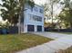 Modern three-story home with a two-car garage and a concrete driveway at 1793 N Fort Harrison Ave, Clearwater, FL 33755