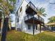 Rear exterior view featuring a concrete patio, two story deck and small grassy yard at 1793 N Fort Harrison Ave, Clearwater, FL 33755
