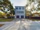 Modern three-story home with a two-car garage and concrete driveway, and large windows at 1793 N Fort Harrison Ave, Clearwater, FL 33755
