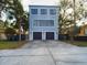 Modern three-story home with a two-car garage and a concrete driveway at 1793 N Fort Harrison Ave, Clearwater, FL 33755