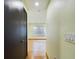 Hallway with hardwood floors leads to a room with window at 1793 N Fort Harrison Ave, Clearwater, FL 33755