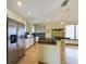 Bright, open kitchen featuring modern appliances, black counters, and wooden floors at 1793 N Fort Harrison Ave, Clearwater, FL 33755