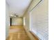 Open living area with light wood floors, two windows, and ceiling fan at 1793 N Fort Harrison Ave, Clearwater, FL 33755