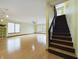 Bright and airy living room with wood floors and staircase to upper level at 1793 N Fort Harrison Ave, Clearwater, FL 33755