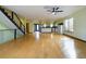 Open living room with wood floors, stairs, view to kitchen with stainless steel appliances at 1793 N Fort Harrison Ave, Clearwater, FL 33755