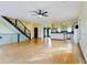 Spacious living room with hardwood floors, modern staircase, and open kitchen layout at 1793 N Fort Harrison Ave, Clearwater, FL 33755