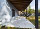 An open-air concrete patio lies under a wooden deck and is next to the home's back exterior wall at 1793 N Fort Harrison Ave, Clearwater, FL 33755