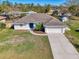 Beautiful single-story home with a two car garage, complemented by a well-manicured lawn and landscaping at 2302 De Garmo St, North Port, FL 34291