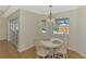 Bright breakfast nook featuring a white table and seating for four with a view of the pool and lanai at 2302 De Garmo St, North Port, FL 34291