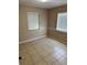 Neutral bedroom with tile flooring and natural light from two windows at 2505 Warne St, Port Charlotte, FL 33952