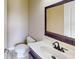 Half bathroom with wood vanity, white countertop and mirror at 5406 Fishhawk Ridge Dr, Lithia, FL 33547