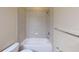 Tiled bathroom with shower and tub combo. Neutral color palette at 5406 Fishhawk Ridge Dr, Lithia, FL 33547