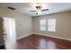 Bedroom featuring wood floors, ceiling fan and natural light from the windows at 5406 Fishhawk Ridge Dr, Lithia, FL 33547
