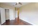 Bedroom with wood floors, ceiling fan, closet, and neutral colored walls at 5406 Fishhawk Ridge Dr, Lithia, FL 33547