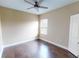 Bedroom with hardwood floors, neutral walls, a ceiling fan, and a window at 5406 Fishhawk Ridge Dr, Lithia, FL 33547