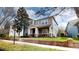 Beautiful two-story home with neutral paint, a well-kept lawn, and colorful garden at 5406 Fishhawk Ridge Dr, Lithia, FL 33547