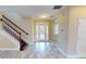 Welcoming foyer featuring a staircase, tile flooring, and a front door with glass panels to let in natural light at 5406 Fishhawk Ridge Dr, Lithia, FL 33547