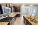 Modern kitchen features stainless steel appliances, granite counters, and new tile floors at 5406 Fishhawk Ridge Dr, Lithia, FL 33547