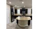 Well-equipped kitchen with stainless steel appliances, dark cabinetry, and a center island with granite countertops at 5406 Fishhawk Ridge Dr, Lithia, FL 33547
