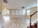 Spacious living room featuring stylish tile floors, natural light, and ceiling fan at 5406 Fishhawk Ridge Dr, Lithia, FL 33547