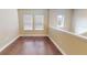 Bright loft area features hardwood floors, two windows and a half wall overlooking the level below at 5406 Fishhawk Ridge Dr, Lithia, FL 33547