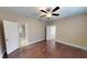Spacious main bedroom with wood floors, a ceiling fan, and an en-suite bathroom at 5406 Fishhawk Ridge Dr, Lithia, FL 33547