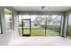 The screened patio overlooks the backyard with lush green lawn and privacy hedge at 5406 Fishhawk Ridge Dr, Lithia, FL 33547