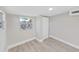 An empty bedroom with a window, wood-look flooring, and white trim at 7151 51St N Ave, St Petersburg, FL 33709