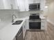 Modern kitchen featuring stainless steel appliances, white cabinets, a stylish backsplash, and solid surface countertops at 7151 51St N Ave, St Petersburg, FL 33709