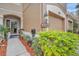 Charming entryway with a decorative lantern, lush greenery, and a welcoming name sign at 8418 Sandy Beach St, Tampa, FL 33634