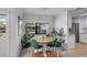 Charming dining area with a round table, decorative rug, and abundant plants, adding a touch of nature at 12723 Pecan Tree Dr, Hudson, FL 34669
