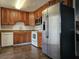Functional kitchen featuring stainless steel appliances, wood cabinets, and tile flooring at 6006 12Th E St, Bradenton, FL 34203