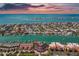 An aerial view shows waterfront condos, private boat docks and a beautiful waterfront location on the water at 722 Pinellas Bayway S # 102, St Petersburg, FL 33715