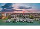 An aerial view showcases waterfront condos, a pool, private boat docks and a beautiful waterfront location at 722 Pinellas Bayway S # 102, St Petersburg, FL 33715