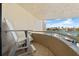 Balcony overlooking waterway with a white chair and metal railing at 722 Pinellas Bayway S # 102, St Petersburg, FL 33715