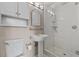 Bright bathroom with pedestal sink and glass-enclosed shower at 722 Pinellas Bayway S # 102, St Petersburg, FL 33715