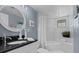Clean bathroom with white tiling, modern fixtures, and a shower-tub combination at 722 Pinellas Bayway S # 102, St Petersburg, FL 33715