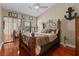 Cozy bedroom featuring wood floors, vaulted ceiling, and natural light at 722 Pinellas Bayway S # 102, St Petersburg, FL 33715