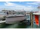 View of a modern boat on a lift, showcasing waterfront property and boating lifestyle at 722 Pinellas Bayway S # 102, St Petersburg, FL 33715