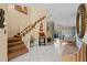 Foyer with staircase, tiled floor, and mirror leading to the living room at 722 Pinellas Bayway S # 102, St Petersburg, FL 33715