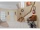 Bright foyer with staircase and decorative touches at 722 Pinellas Bayway S # 102, St Petersburg, FL 33715