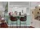 View of the kitchen from the foyer with bar stools at 722 Pinellas Bayway S # 102, St Petersburg, FL 33715