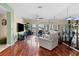 Bright living room with hardwood floors and sliding glass doors at 722 Pinellas Bayway S # 102, St Petersburg, FL 33715